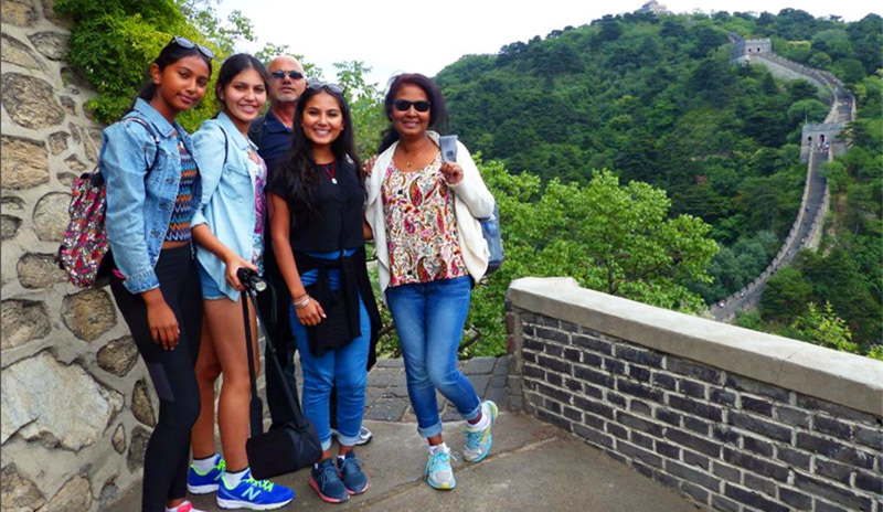 Deborah her husband and three girls at the Great Wall