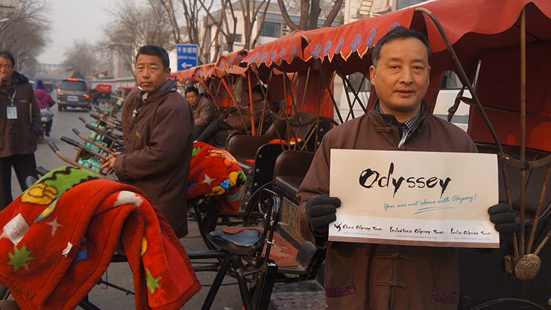 The rickshaw driver is holding our logo